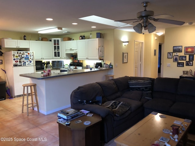 tiled living room featuring ceiling fan