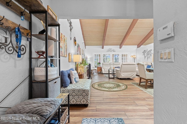 living room featuring lofted ceiling with beams and wood ceiling