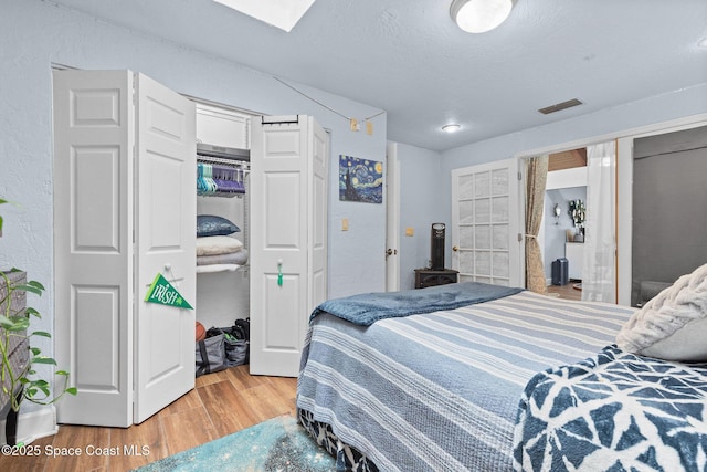 bedroom featuring a textured ceiling, a closet, and wood-type flooring