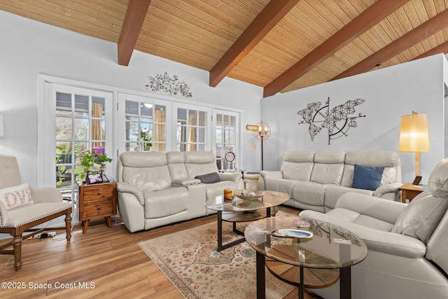 living room with hardwood / wood-style flooring, wooden ceiling, and vaulted ceiling with beams