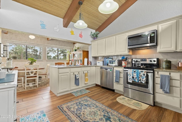 kitchen featuring light hardwood / wood-style floors, kitchen peninsula, wooden ceiling, stainless steel appliances, and beamed ceiling