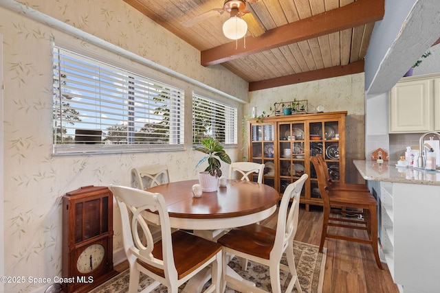 dining space with wood ceiling, ceiling fan, dark hardwood / wood-style flooring, beam ceiling, and sink