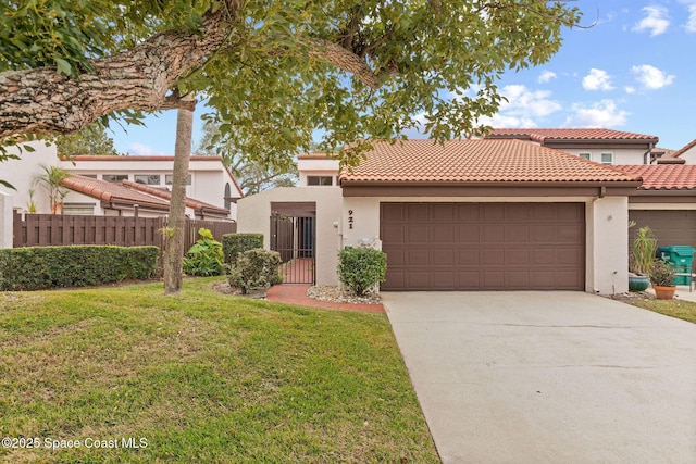 mediterranean / spanish-style home featuring a front yard and a garage