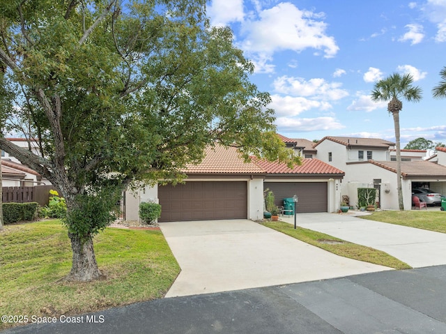 view of front of home with a front lawn and a garage