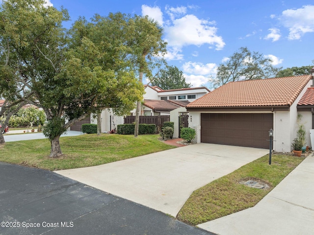 view of front of property featuring a front lawn and a garage