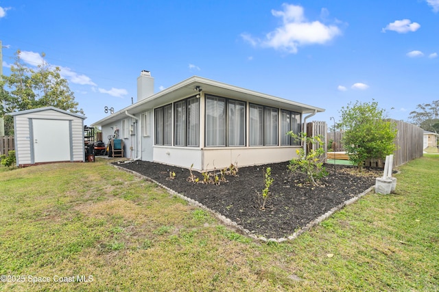 view of property exterior featuring a storage shed, a yard, and a sunroom