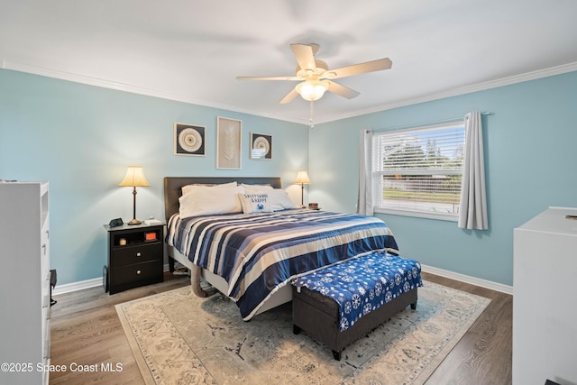 bedroom featuring hardwood / wood-style flooring, ceiling fan, and ornamental molding