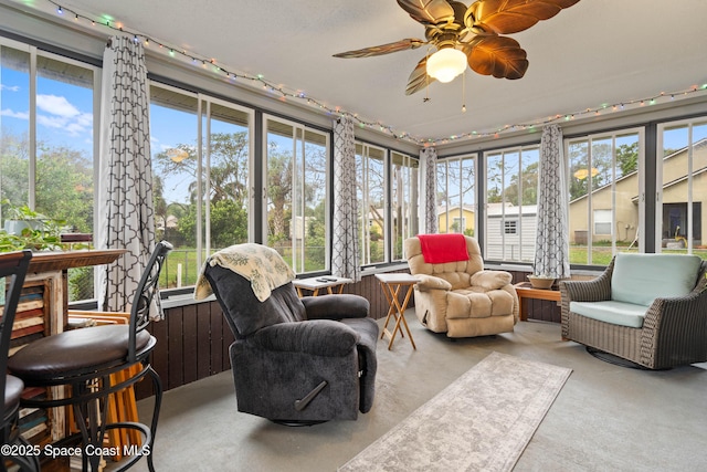 sunroom / solarium featuring plenty of natural light and ceiling fan