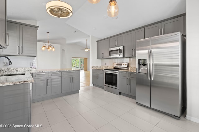 kitchen with appliances with stainless steel finishes, sink, gray cabinetry, and backsplash