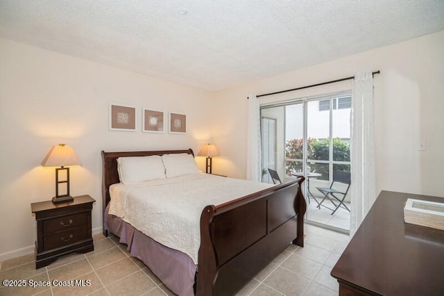 bedroom with access to exterior, a textured ceiling, and light tile patterned flooring