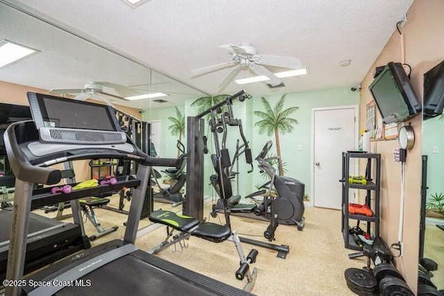 exercise room with a textured ceiling and ceiling fan