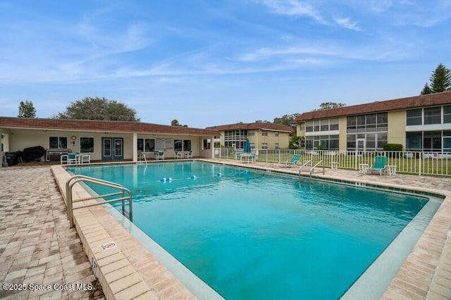 view of swimming pool featuring grilling area and a patio area