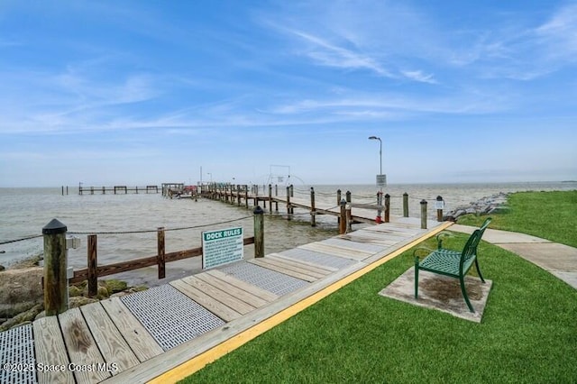 dock area featuring a water view and a yard