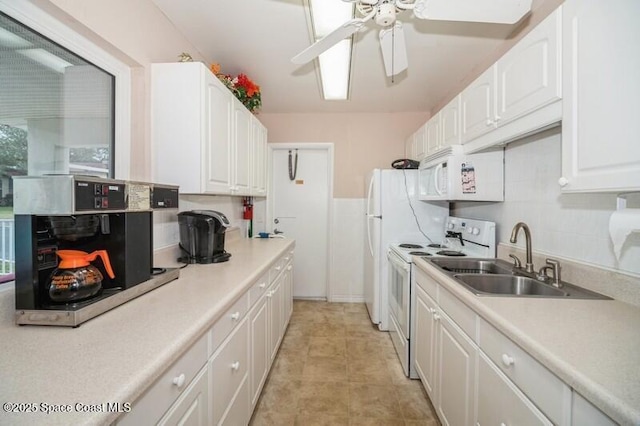 kitchen with white cabinetry, sink, ceiling fan, and white appliances