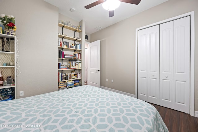 bedroom with dark wood-type flooring, a closet, and ceiling fan