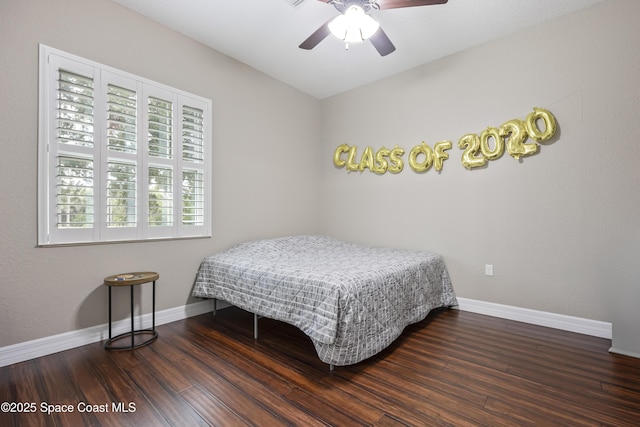 bedroom with ceiling fan and dark hardwood / wood-style flooring