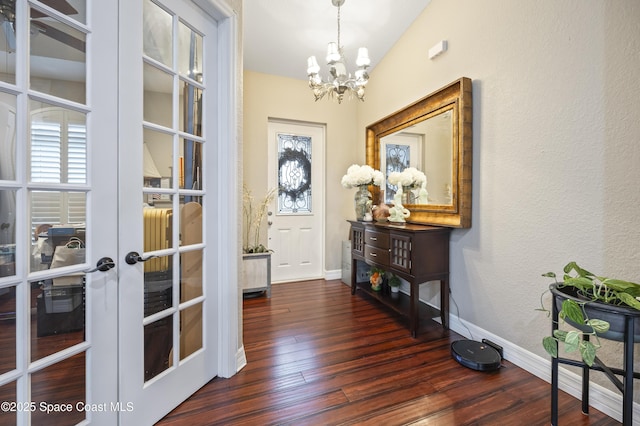 doorway to outside with french doors, dark hardwood / wood-style floors, and a notable chandelier