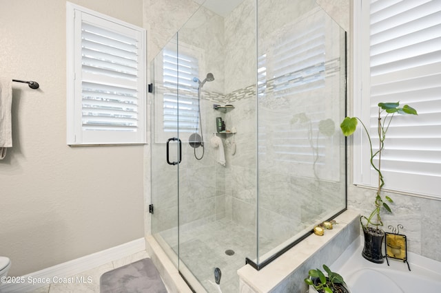 bathroom with tile patterned flooring, shower with separate bathtub, and toilet