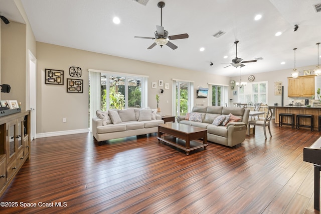 living room featuring dark hardwood / wood-style floors and ceiling fan