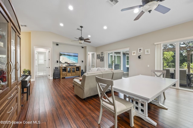 dining room with lofted ceiling, dark wood-type flooring, and ceiling fan