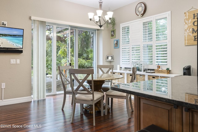 dining area featuring a notable chandelier and dark hardwood / wood-style flooring