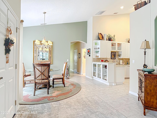 dining space with a chandelier and light tile patterned floors