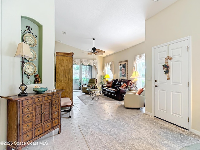 tiled foyer with lofted ceiling and ceiling fan