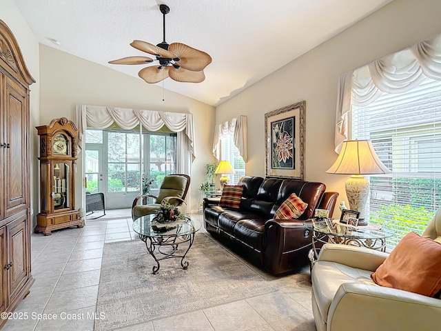 tiled living room featuring ceiling fan and vaulted ceiling