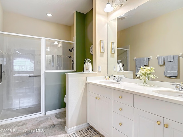 bathroom with vanity, tile patterned floors, and a shower with shower door