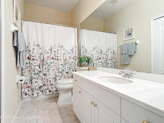 bathroom featuring vanity, toilet, and tile patterned flooring