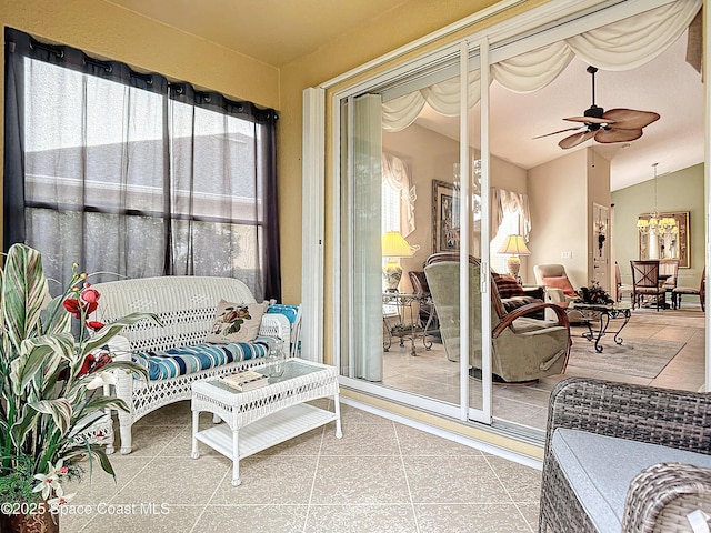 sunroom featuring a healthy amount of sunlight, vaulted ceiling, and ceiling fan