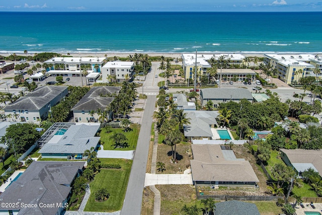 birds eye view of property with a water view and a view of the beach