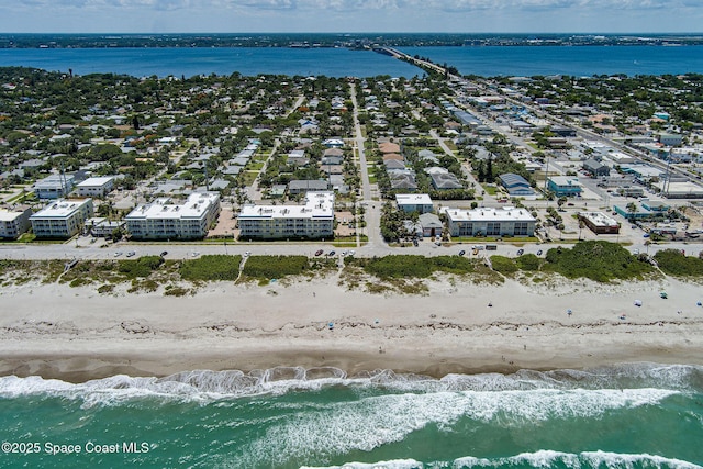 aerial view with a water view and a view of the beach