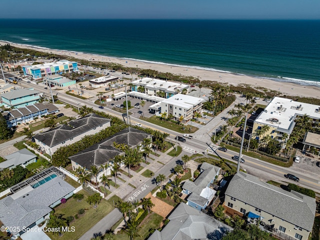 drone / aerial view featuring a water view and a beach view