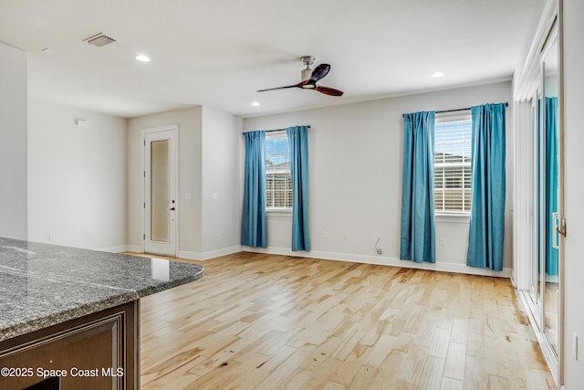 interior space featuring light hardwood / wood-style floors and ceiling fan