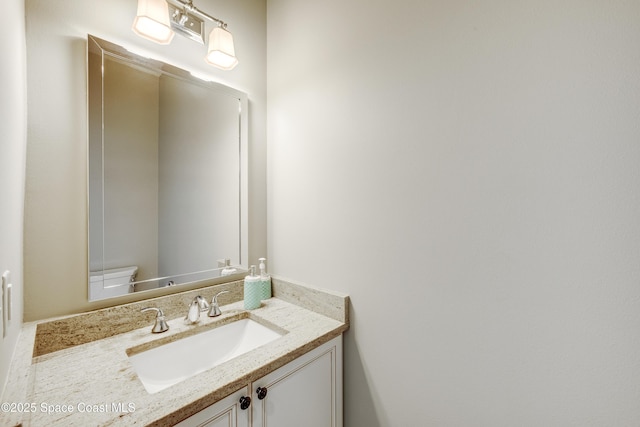 bathroom with vanity and toilet