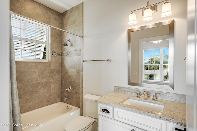 full bathroom featuring vanity, shower / bath combination with curtain, and toilet