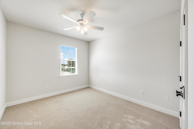 unfurnished room with ceiling fan, light colored carpet, and a textured ceiling