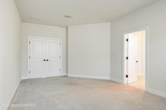 empty room featuring light colored carpet