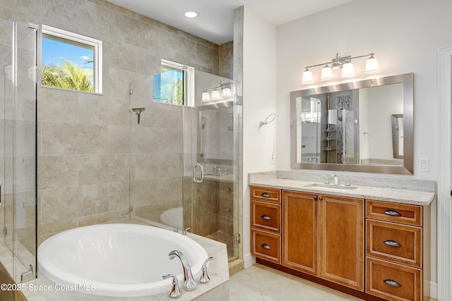 bathroom featuring shower with separate bathtub, tile patterned floors, and vanity