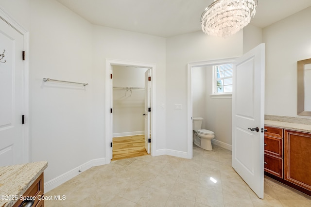 bathroom featuring tile patterned flooring, vanity, and toilet