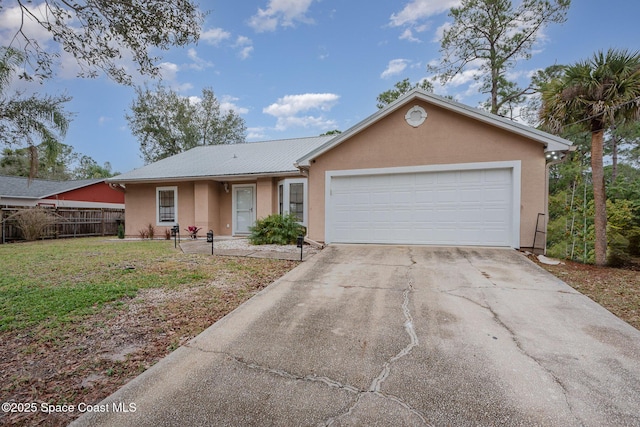 single story home featuring a garage and a front yard