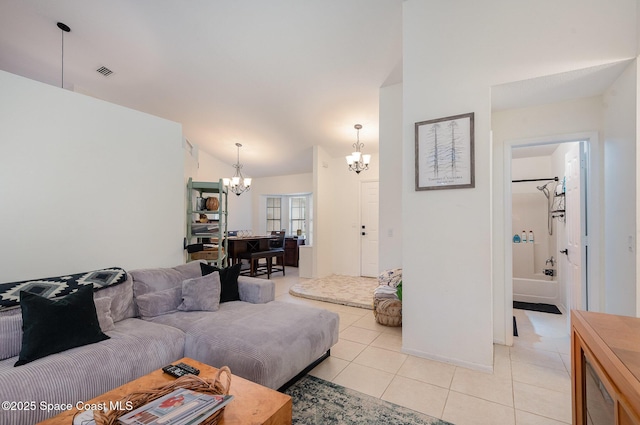 tiled living room with vaulted ceiling and a notable chandelier