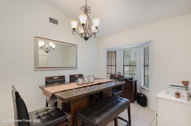 dining room with lofted ceiling, a chandelier, and light tile patterned floors