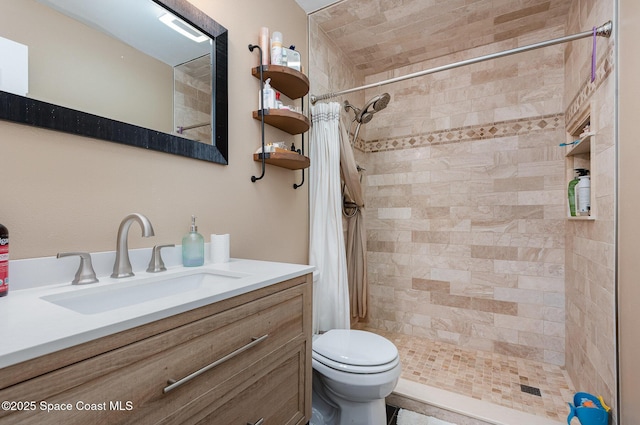 bathroom with walk in shower, vanity, and toilet