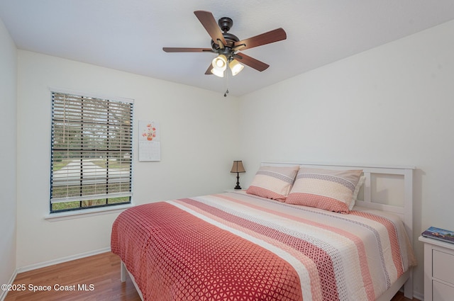 bedroom with light hardwood / wood-style floors and ceiling fan