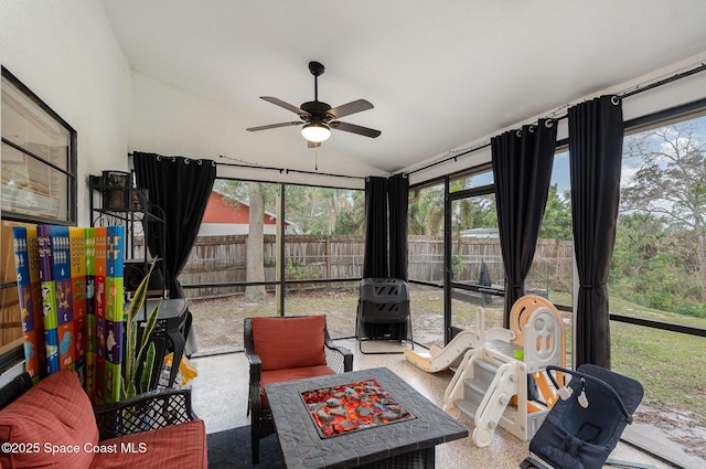 sunroom with ceiling fan, plenty of natural light, and vaulted ceiling