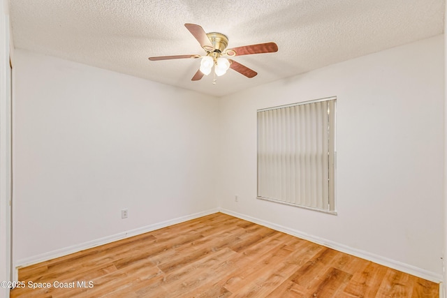 empty room with hardwood / wood-style floors, a textured ceiling, and ceiling fan