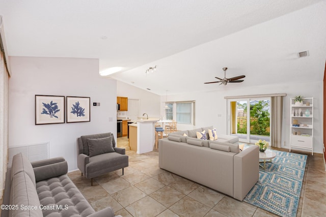 tiled living room with ceiling fan and lofted ceiling