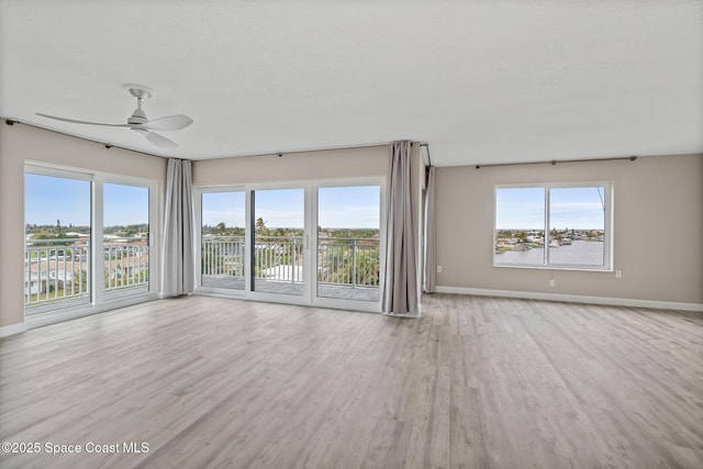 spare room featuring ceiling fan and light hardwood / wood-style floors